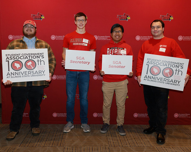 Students holding SGA signs