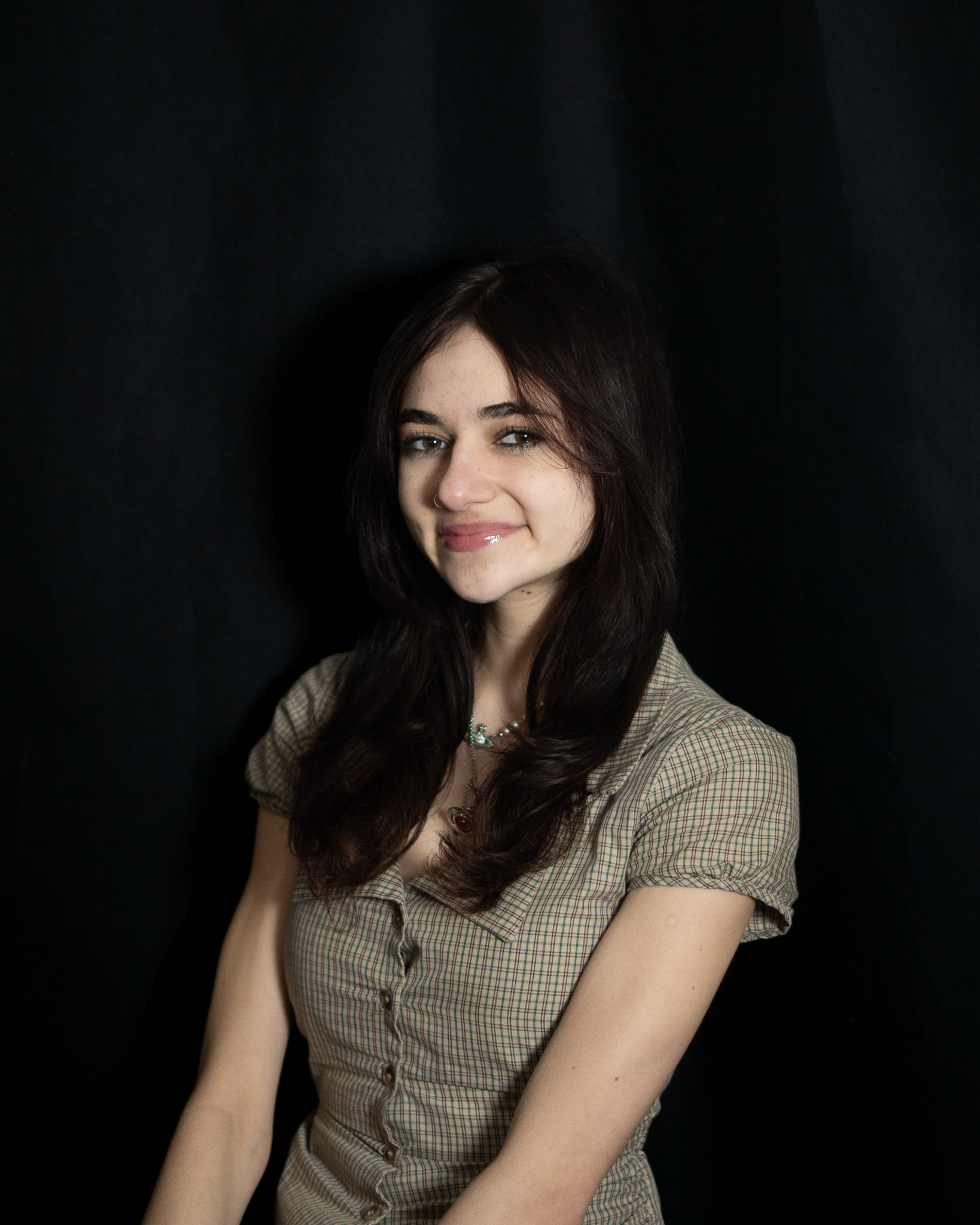 Jovana Emerick smiling with a black background