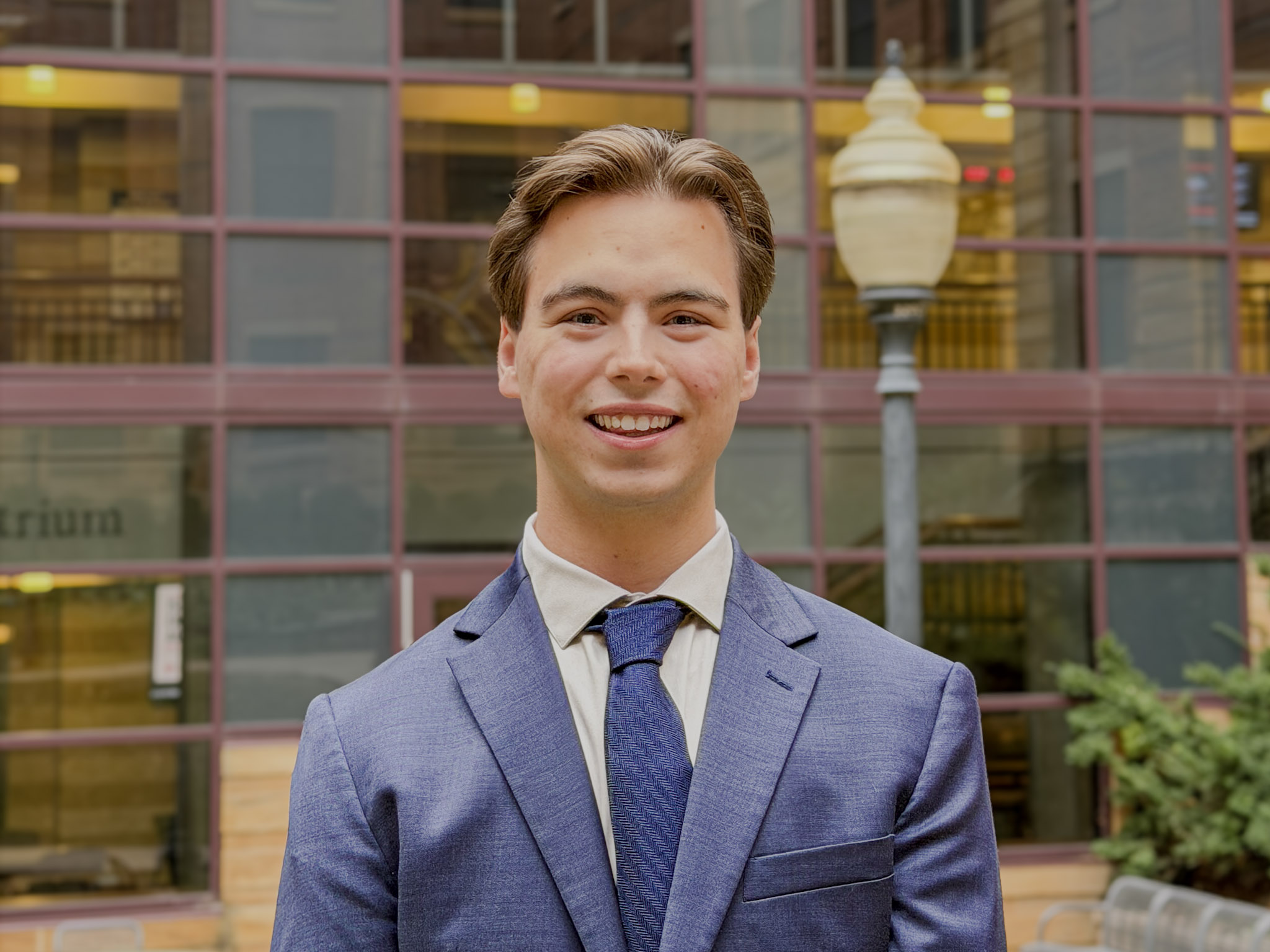 Ethan Short standing infront of the State Farm Hall of Business