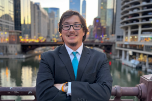 Matt Saner standing with a city skyline in the background